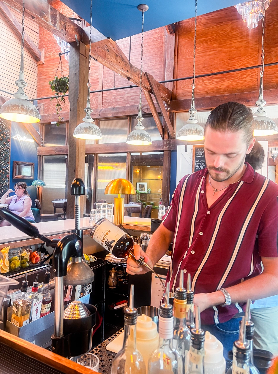Bartender crafting a cocktail at local restaurant in North Carolina