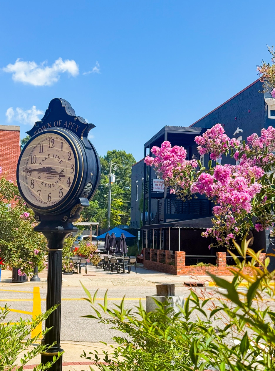 Charming downtown Apex NC streetscape with blooming flowers and clock