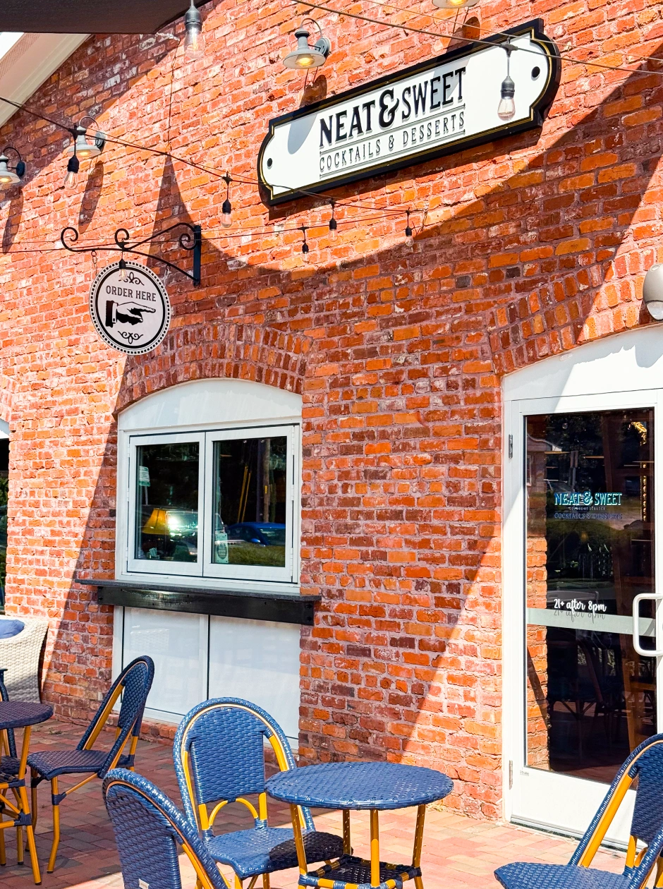 Brick storefront of Neat and Sweet in Apex NC historic district