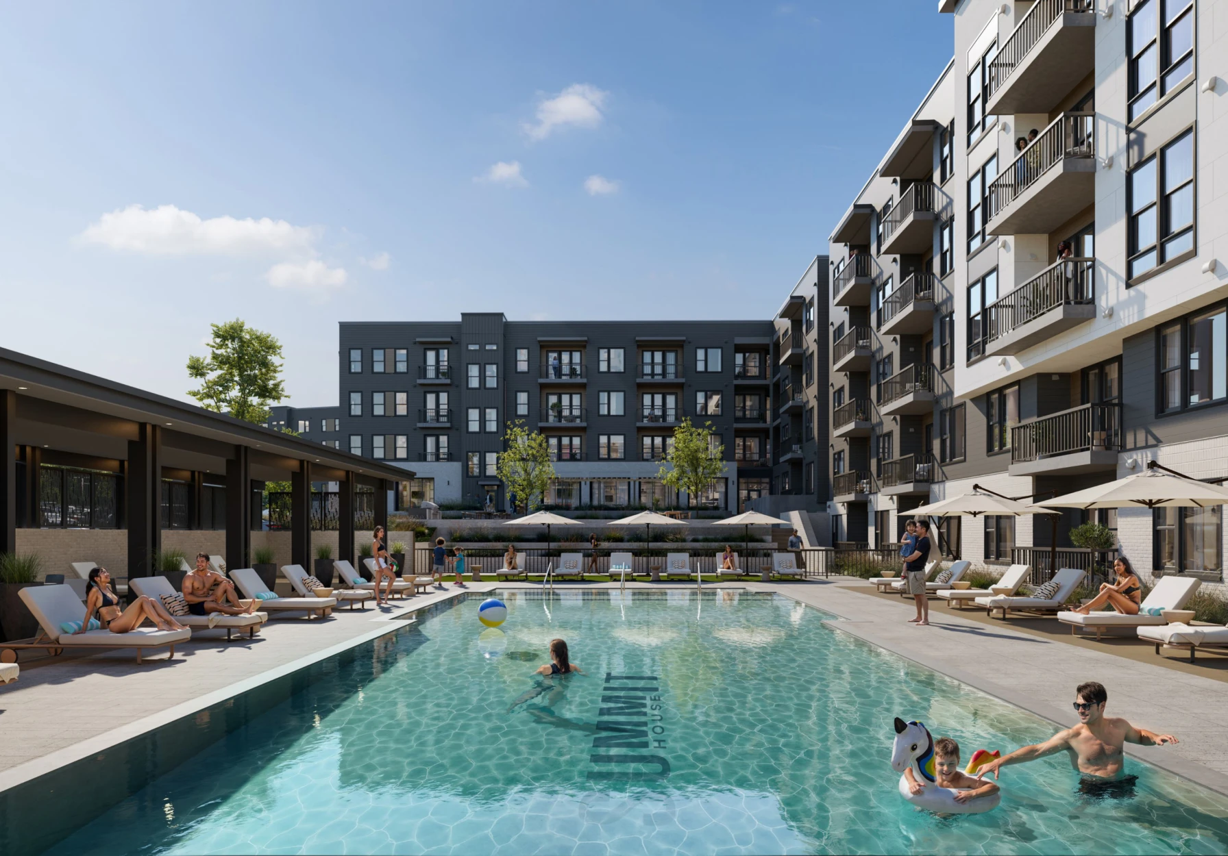 Luxury multifamily housing courtyard featuring swimming pool sundeck seating and balconies overlooking shared outdoor space