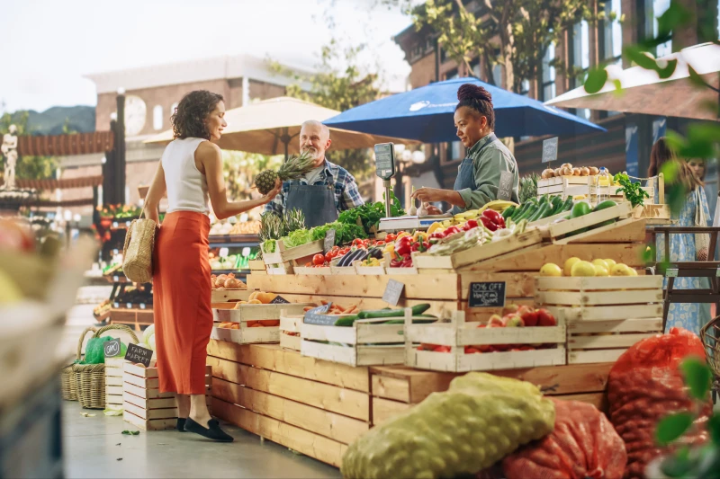 Residents shopping for fruits and vegetables at outdoor farmers