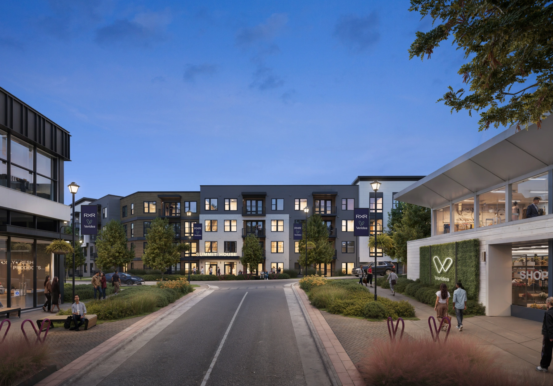 Contemporary urban residential complex with illuminated windows landscaped sidewalks and active