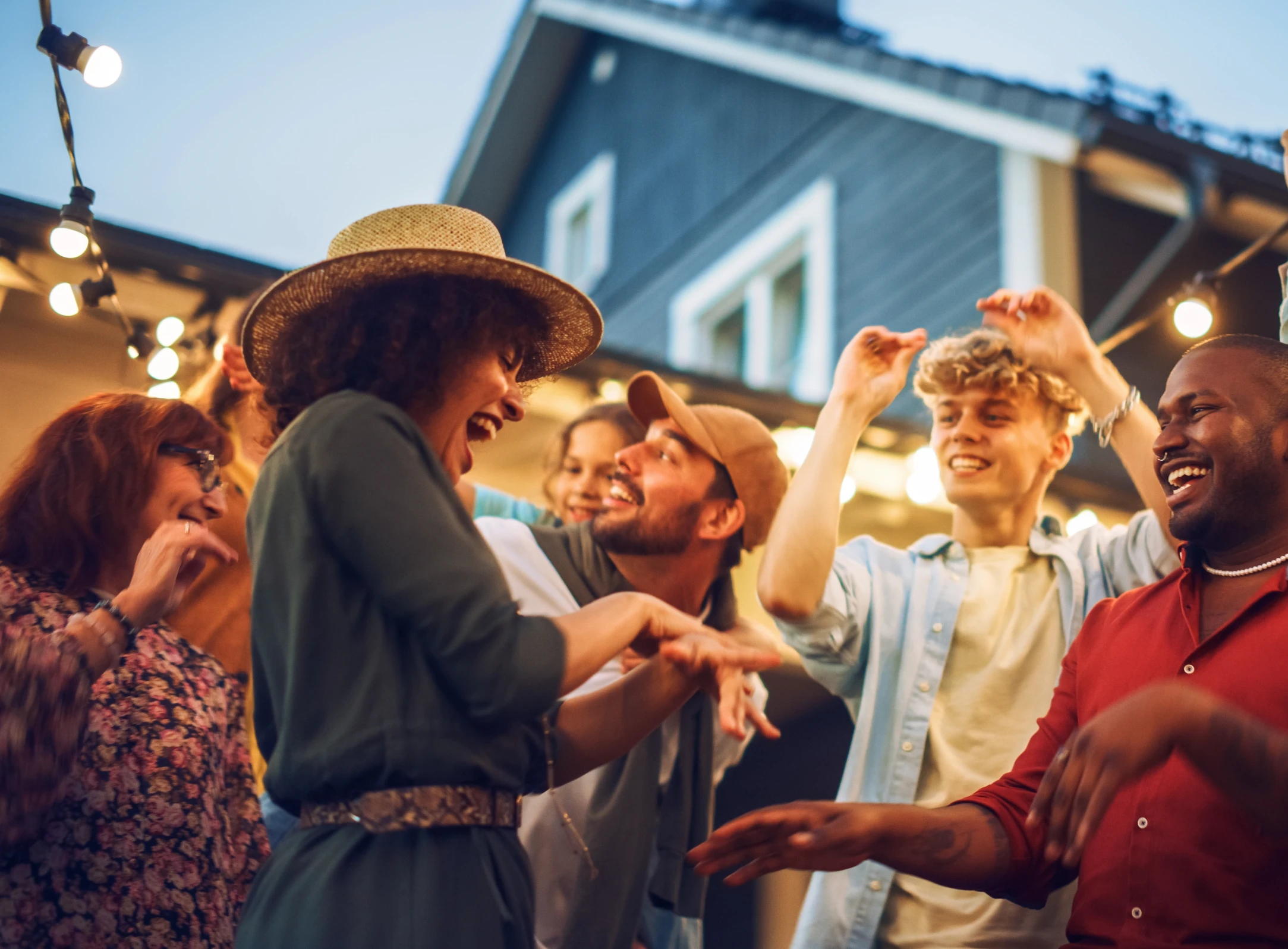 Friends celebrating outdoors in Apex North Carolina under string lights
